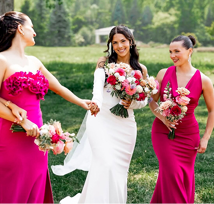 Bride walking with bridesmaids holding flowers